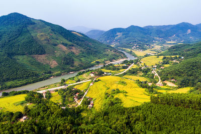 High angle view of green landscape against sky