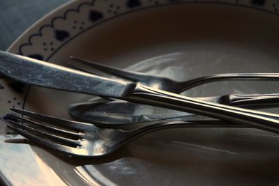 Close-up of knife and fork on plate