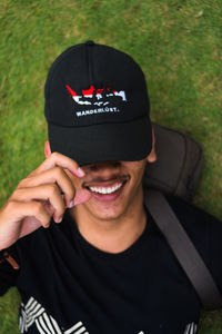 Close-up portrait of smiling man holding hat