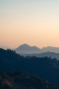 Scenic view of silhouette mountains against sky at sunset