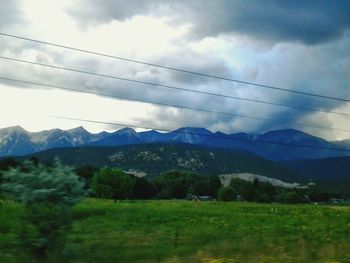 Scenic view of mountains against cloudy sky