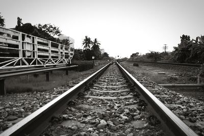 Surface level of railroad tracks against clear sky