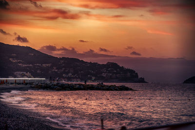 Scenic view of sea against orange sky