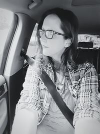 Young woman sitting in car