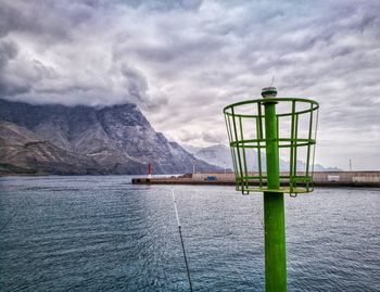 View of bridge over river against cloudy sky