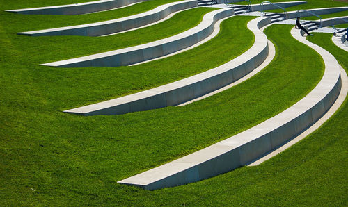 Empty benches on grassy field