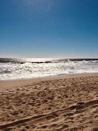 Scenic view of beach against clear sky