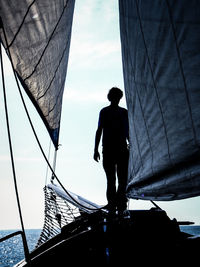 Low angle view of people against clear sky