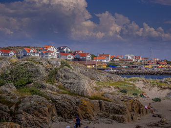 Scenic view of sea by buildings against sky