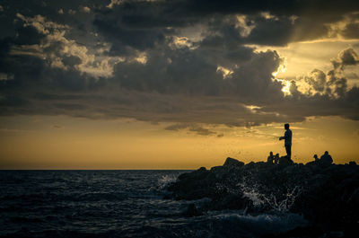 Silhouette of lighthouse at seaside