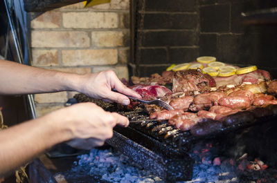 Man preparing food on barbecue grill
