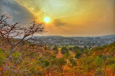 Scenic view of landscape against sky at sunset