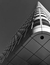 Low angle view of skyscraper against clear sky at night