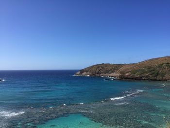 Scenic view of sea against clear blue sky