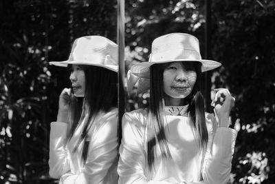 Portrait of woman wearing hat standing outdoors