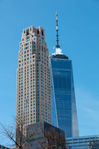 Low angle view of modern buildings in city against sky