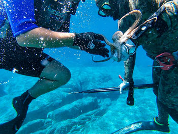 Reflection of people in swimming pool