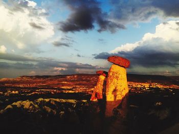 Scenic view of landscape against cloudy sky