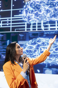 Side view of young man holding hands