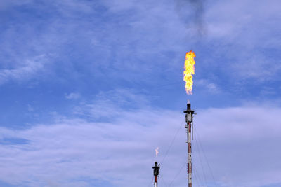 Low angle view of communications tower against sky