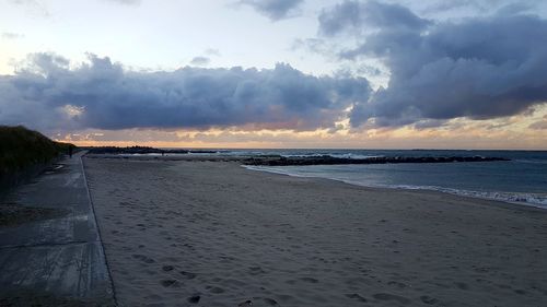 Scenic view of beach against sky during sunset