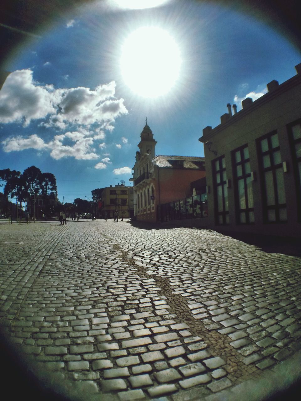 building exterior, architecture, built structure, sunlight, sky, sun, sunbeam, cobblestone, lens flare, sunny, shadow, cloud - sky, city, day, house, street, cloud, outdoors, building, residential building