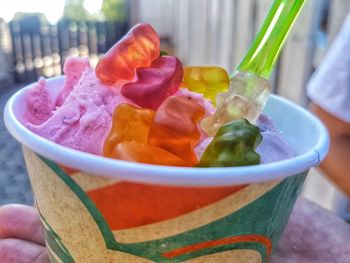 Close-up of hand holding ice cream in bowl