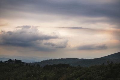 Scenic view of mountains against cloudy sky