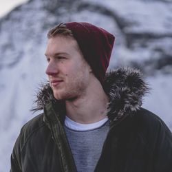 Portrait of young man looking away during winter