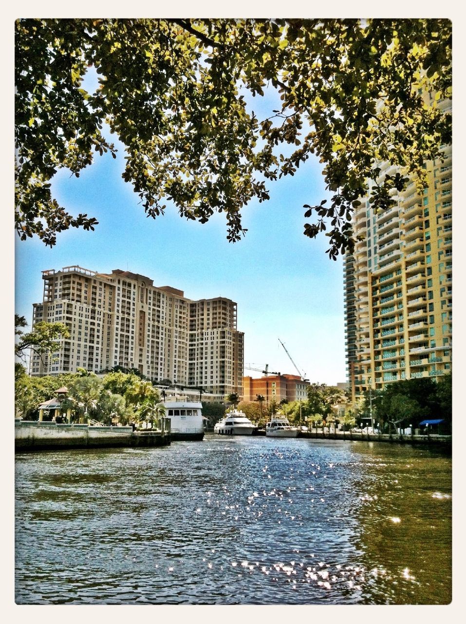 building exterior, architecture, built structure, transfer print, city, water, tree, auto post production filter, waterfront, river, cityscape, skyscraper, building, sky, residential building, office building, tower, clear sky, day, city life