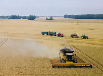 Tractor on agricultural field against sky