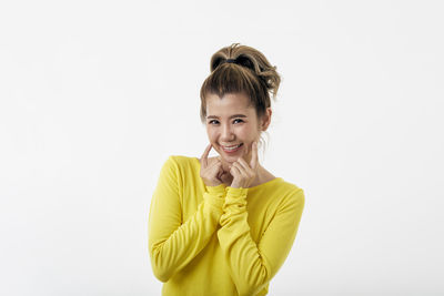 Portrait of a smiling young woman over white background