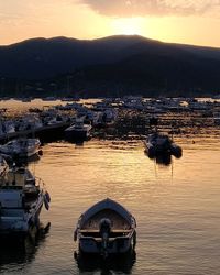 High angle view of boats moored on sea against sky during sunset