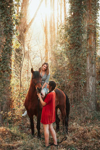 Women with horse in forest