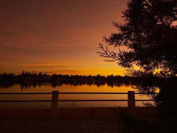 Scenic view of lake against orange sky