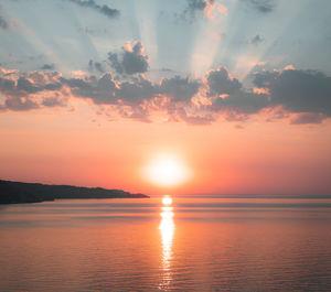 Scenic view of sea against romantic sky at sunset