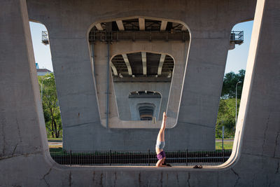 Low angle view of woman walking on bridge