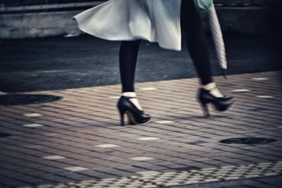 Low section of woman walking on floor