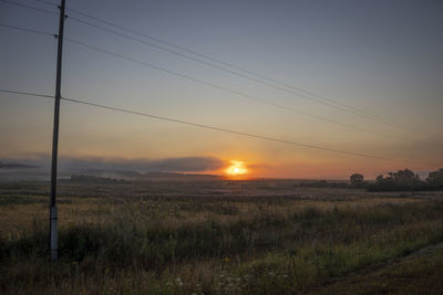 Scenic view of field against sky during sunset