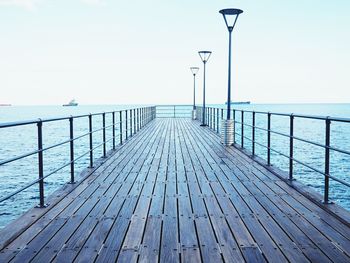 Pier over sea against clear sky