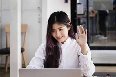 Portrait of young woman using phone