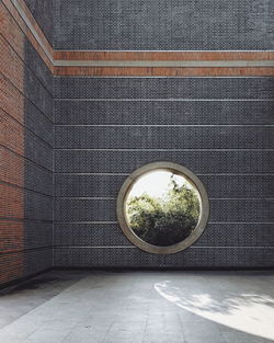 Circular window on brick wall