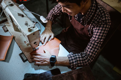 Midsection of man working in workshop