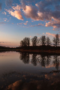 Scenic view of lake against sky at sunrise 