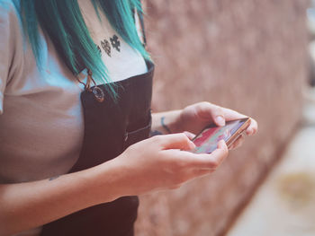 Midsection of woman using mobile phone