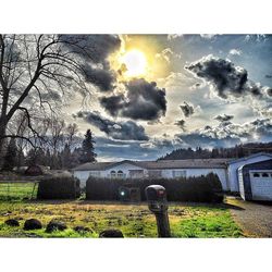 Scenic view of field against cloudy sky