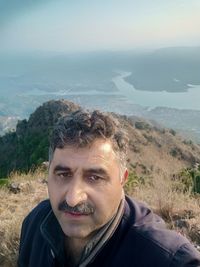 Portrait of man in mountains against sky