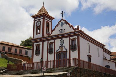 Low angle view of church against cloudy sky