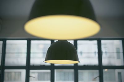 Illuminated pendant light hanging from ceiling