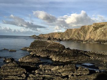 Rocks on beach against sky